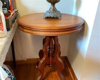 Beautiful oval walnut side table with castors.  Metal base lamp with custard glass shade.  
