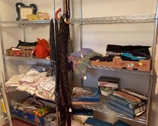 Scarves, kitchen items, sheets, purses.  Metal shelving units are not for sale.