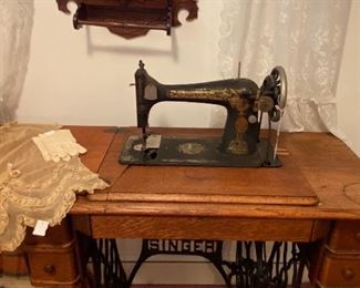 Singer sewing machine with wooden work surface. Work surface hinge needs repair.