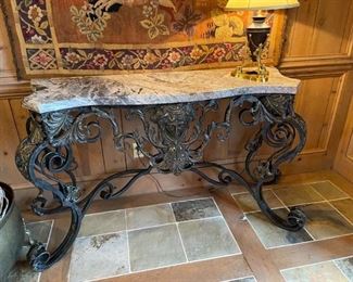 Exquisite marble top table with iron base.  34 1/2”H x56”W x 21 1/2” D