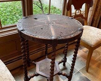 Spool  Leg Table with Caned Top.  Round table with nice inlay and a lower shelf.  Some imperfections with the caning.  39”H x 26”W