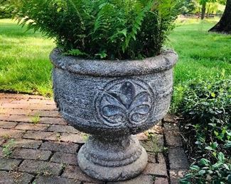 Rather large cast stone urn, has a crack