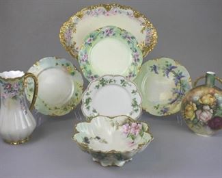 18 Haviland Limoges Hand Painted Porcelain Grouping 8 pieces of hand painted French porcelain. 2 handled vase, signed on the underside with the artist's monogram and dated 1908, 9 1/4"H; plate with leaf and flower decoration, Haviland & Co. for Mayer & Co., Indianapolis, Indiana, 8 1/4"-diameter; set of 3 plates with scalloped rims, each 9 3/4"-diameter; pitcher with floral decoration and gilt painted handle & rim, 9 3/4"H; serving bowl with blackberries & flowers, signed on the underside Kayser, 10"-diameter; platter, with gilt painted rim, artist initialed AC, 16 1/4"L. All signed Haviland France except pitcher and platter, both signed Theodore Haviland. Minor losses to gilt on serving bowl rim.