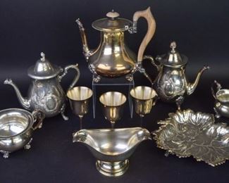 22 Silverplate Grouping 10 pieces of silverplate. 2 teapots, both marked in Arabic and with Ghiiouanes Fes, each 9"H, both inscribed on the underside The Manor; Rand teapot with wooden handle and finial and matching sugar & creamer, teapot 9 1/4"H; Sambonet sauce boat, 7 3/4"L; leaf form tray, Crescent Silverware Mfg. Co., 11"L; 3 Salem wines, each 5 3/4"H