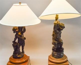 28 Pair of Composition Cherub Lamps Pair of figural cherub composition lamps, mounted on wooden bases. 25 1/2"H and 24 1/2"H to top of lamp fittings. Mismatched finials