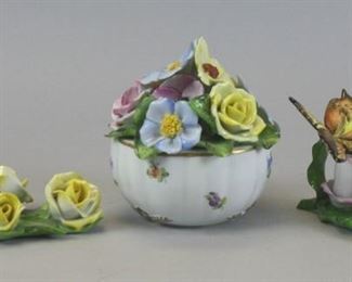 42 3 Herend Porcelain Flower Groups 3 hand painted porcelain flower groups. Yellow roses on leaves, 7"L; butterfly and flowers, 5 1/2"L x 3 1/2"H; Printemps pattern bowl with bouquet of flowers, 5 1/4"H. Roughness on one yellow rose. All stamped Herend Hungary Handpainted and incised Herend on the underside.