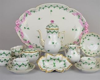 46 17 Piece Herend Persil Porcelain Demitasse Set 17 piece hand painted Herend porcelain demitasse set in the Persil pattern. Small coffee pot with lid with pink flower finial, creamer, lidded sugar bowl with pink flower finial, 6 cups & saucers, small dish, ribbon tray. Coffee pot 6 3/4"H, dish 6"L, tray 16"L. Finials chipped on both coffee pot and sugar bowl, chip to inner rim of coffee pot lid. All with early 20th century Hungary mark, except dish, with contemporary Herend Hungary mark.