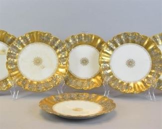55 Set of 6 Klingenberg & Dwenger Limoges Plates With gilt painted rims with floral decoration and gilt painted center decoration, marked on the underside AK | CD Limoges France and additionally stamped with the Coiffe Limoges star, each 9 1/2"-diameter. Losses to gilt throughout.