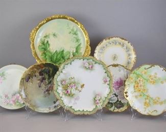 57 Grouping of Limoges Plates & Platters 7 pieces of hand painted Limoges porcelain. 2 T&V Limoges (Tressemanes & Vogt) plates: 1 with blackberry decoration, 10 1/4"-diameter & 1 with floral decoration, 9 1/4"-diameter; PL Limoges (La Porcelaine Limousine) 2 handled cake plate, artist signed on the underside SC. Headley, 10 1/2"L including handles; Coronet cake plate, 10 1/2"-diameter; Flambeau plate, 9 3/4"-diameter; A. Lanternier & Co serving plate, 12"-diameter; JPL (Jean Pouyat Limoges) charger, with flowers, leaves & pea pod decoration, 12 3/4"-diameter