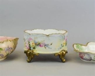 61 3 Limoges Porcelain Bowls All hand painted. H & Co. (Haviland & Co.) leaf form bowl with gilt painted floral decoration and pink interior, 9 1/2"L x 3 1/2"H; LS & S (Lewis Strauss & Son) leaf form bowl with gilt painted rim and floral decoration, artist signed Angel, 9 1/2"W x 2"H; Klingenberg & Dwenger footed center bowl, with floral decoration and gilt painted rim and feet, 4 1/2"H x 7 1/2"-diameter. Minor losses to gilt on all.