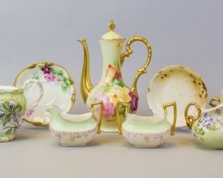 63 Grouping of Limoges Porcelain 14 pieces of Limoges porcelain, all hand painted with floral decoration. T&V (Tressemanes & Vogt) teapot, artist signed on the underside E. Launitz-Raymond and dated 1908, 4 3/4"H (no lid); 2 T&V sugar and creamer sets, larger creamer 5 1/2"L; T&V cup, signed on the underside Lucy and dated '09, 3 1/2"H; T&V saucer, 5 1/2"-diameter; Haviland berry bowl, 5"-diameter; GDA France creamer, 3 1/4"H; 4 T&V bouillons, each 5 1/2"-diameter; WG & Co. (William Guerin & Co.) chocolate pot, 9 3/4"H. Losses to gilt on bouillons.