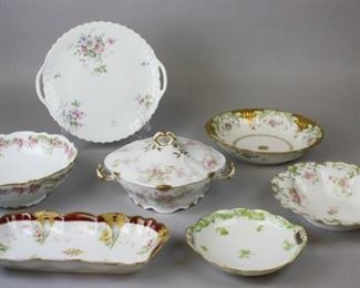 67 Limoges Porcelain Grouping 7 pieces of Limoges porcelain. Elite serving bowl, 3 1/4"H x 9 1/4"-diameter; GDA serving bowl, 9 1/2"-diameter; CFH | GDM bowl, 7 1/2"-diameter; LS & S (Lewis Strauss & Son) serving bowl, 10 1/2"-diameter; Georges Boyer for B. Altman & Co. cake plate, 11 1/2"-diameter; A. Lanternier rectangular dish, 12 1/4"L; Charles Ahrenfeldt covered vegetable, 5 1/2"H. Chips on rim of LS & S bowl.