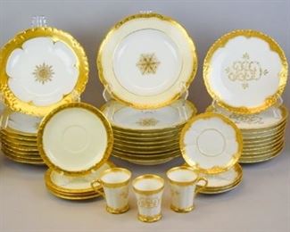 70 Limoges & Rosenthal Gilt Decorated Dinnerware 39 pieces of gilt painted Limoges dinnerware. An 18 piece partial Theodore Haviland monogrammed coffee set: 10 dessert plates, 4 saucers, 3 demitasse cups, coffee pot (no lid); 8 WG & Co. (William Guerin & Co.) bowls with cream and gilt rims and white centers with gilt snowflakes; 8 Charles Ahrenfeldt bowls with gilt rims and gilt snowflake centers; a J. (Jean) Pouyat coffee or chocolate pot with gilt painted and floral decoration; 4 Rosenthal Selb-Bavaria Maria pattern saucers. 1 William Guerin bowl chipped on underside of rim. Guerin bowls 9"-diameter, Pouyat coffee pot 11 1/2"H