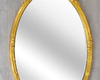 80 Decorative Arts Inc. Giltwood Mirror Oval neoclassical giltwood mirror, with scrolls, flowers and acanthus leaf decoration. Decorative Arts Inc. New York label. 47" x 26"