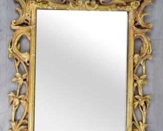 82 Decorative Arts Inc. Carved Giltwood Mirror Rectangular neoclassical giltwood mirror with acanthus leaf and flower decoration. With Decorative Arts Inc. Miami Florida label. 60" x 36". Some cracks to wood. 1 of a pair with lot 81