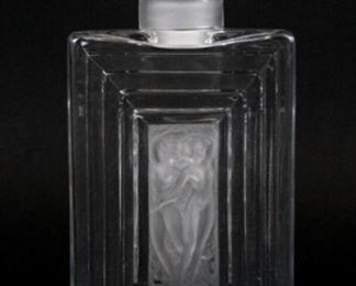 89 Lalique Duncan Crystal Decanter Rectangular crystal Duncan decanter, with two intertwined nudes in frosted glass in the center, and a frosted stopper. Contemporary Lalique France signature and Made in France paper label on the underside. 8"H including stopper