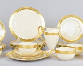 95 Lenox Green Mark Tea Service 25 pieces. Cream with gilt trim. 6 dessert plates, 6 bread & butter plates, 5 saucers, 5 cups, teapot, creamer, lidded sugar bowl. With green Lenox backstamp, and Lenox, Made Exclusively for Frederick Keer's Sons, Newark, NJ, and numbered in gold C2. Teapot 10 1/2"L x 6 1/2"H, largest plates 7 1/4"-diameter. Sugar bowl repaired, cracked.