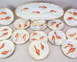 99 15 Piece Limoges Porcelain Fish Set Hand painted Limoges porcelain fish set, consisting of a platter, 12 plates and a sauce boat and underplate. Platter, sauce boat and underplate all T&V (Tressemanes & Vogt), plates Haviland. Plates 8 3/4"-diameter, platter 24"L. Some gilt loss to platter, one plate chipped.
