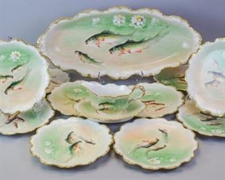 100 15 Piece Limoges Porcelain Fish Set Hand painted Flambeau France Limoges porcelain fish set, consisting of a platter, 12 plates and a sauce boat and underplate. All marked with Flambeau torch mark. Platter 24"L, plates 9 1/4"-diameter. All artist signed. Gilt loss on handle of sauce boat.