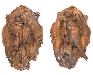 107 Pair of Black Forest Carved Game Plaques Pair of carved wooden plaques depicting game birds, with leaf decoration along edges. Each approximately 33"H x 21 1/2"W. Cracks and chips to both.