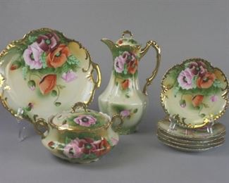 146 8 Piece ZS & Co Royal Munich Porcelain Dessert Set 8 pieces of hand painted porcelain: coffee pot, large lidded sugar bowl or jar, 5 dessert plates, 2 handled cake plate. All with poppy motif, and signed by the artist Rouvier. With Z.S. & Co. (Zeh, Scherzer & Co.) Marseille Bavaria and Royal Munich marks on underside. Coffee pot, 11"H; cake plate 11 1/2"-diameter including handles