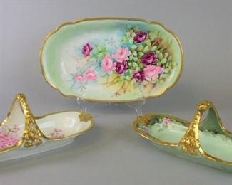 151 Three Limoges Serving Dishes Lot includes two hand painted gilt and floral motif handled celery dishes, marked T&V Limoges, one artist signed, 13 3/4" L x 5 1/2" H, no chips; hand painted gilt and rose shallow serving bowl, 15 1/2"L x 9 1/2"W, no chips.