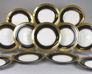 155 Set of 12 A. Lanternier Limoges Service Plates Set of 12 porcelain service plates with white centers, a band of gilt Greek key decoration, cobalt and leaf decorated gilt rims. All marked on the underside A. Lanternier & Co. Limoges France. Each 10 3/4"-diameter