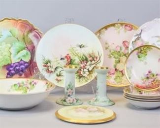 161 Grouping of Porcelain Plates, Candlesticks & More Lot includes artist signed gilt and grape motif hand painted plate marked with Royal Vienna Peinture Alamain ZS&C Bavaria, 10"diameter; gilt and bees motif plate, 9"diameter; gilt and fruit motif, marked Bavaria, 10" diameter; Gilt and fruit motif Sevres plate, 9 1/2" diameter; gilt and grape motif hand painted bowl marked Imperial Austria PSL, 9 1/2" diameter, no chips, five gilt and grape motif hand painted berry bowls, marked Imperial Austria, 5 1/2"diameter, no chips; gilt and rose motif trivet, 6 1/2"diameter, some paint wear from use; artist signed and dated gilt and boy with boat hand painted mug, marked Bavaria, 7"T, no chips; O&EG Royal Austria gilt and floral handpainted candlesticks, 4"T, some paint wear from use, no chips; gilt and floral hand painted teapot marked Vienna Austria, 6 1/2"T, no chips.