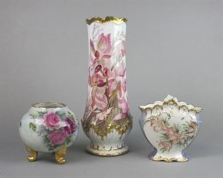 164 Lot of Three Porcelain Vases Tall Flambeau Limoges gilt and floral hand painted vase, 14"T x 6"W, no chips; gilt and floral hand painted vase with D&C France mark, 6"T x 6 1/2"W, no chips; artist signed gilt and floral hand painted round footed vase, no maker's mark, 5 1/2"T x 6"W, no chips.