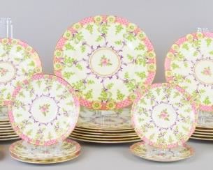 165 Cradley Reproduction Royal Worcester Porcelain Set Royal Worcester partial table service, reproduction of early Worcester in the "Cradley" pattern (circa 1768), having a repeating floral design with gilt and pink border. Lot includes seven dinner plates, 11" diameter, six luncheon plates 9" diameter, nine salad plates, 8" diameter, some chips; one bread and butter plate, 6" diameter; four cream soup bowls, 6"W, no chips; five cream soup saucers, 6" diameter, some chips; three tea cups, two with lines, 5"W; four saucers, 6" diameter