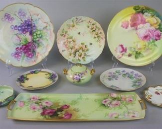 170 Grouping of Continental Porcelain Lot includes hand painted gilt and rose motif rectangular platter, no maker's mark, 19"L x 6 1/2"W, no chips; hand painted gilt and rose motif round serving plate, marked NADW, 11 1/2"diameter, no chips; artist signed hand painted gilt and grape motif large serving plate, marked D&C France, 13" diameter, no chips; gilt and bee plate, marked T&V Limoges, 9 1/2"diameter; gilt and floral hand painted plate, marked M&Z Austria, 8"diameter; hand painted marked B&C, artist signed gilt and floral plate 7 1/2" diameter, no chips; small gilt and floral hand painted plate marked TV Limoges France, 6"diameter, no chips; small gilt and floral hand painted dish marked GDA, 5 1/2" diameter, no chips; GDA gilt and floral hand painted sugar bowl, 3 1/2"T x 6"W, some paint wear from use.