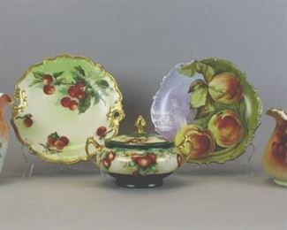 167 Grouping of Five Porcelain Serving Pieces Lot includes hand painted pitcher with cherry motif marked JP Limoges, 6"T x 9" W, 5" diameter; gilt rimmed plate with cherry motif measures 10 1/2" diameter, repaired chip; gilt rimmed Favorite Bavaria artist signed pitcher with peach motif, 8"T x 8 1/2"W; lidded soup tureen marked JMC Limoges with cherry motif measures 9" across; artist signed hand painted Flambeau plate with peach motif, holes in back for hanging, no chips or cracks, 10 1/2"diameter.