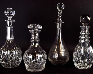 176 4 Crystal Decanters 9 1/2"H, 11 1/2"H, 13"H, 14"H. Tallest signed Wedgwood. Inner edge of stopper chipped on shortest.
