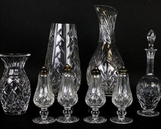 175 8 Piece Crystal Grouping Including Waterford 2 pairs of Waterford salt & peppers with silverplate lids, each 6 1/4"H; Waterford flower vase, 9"H; vase, 7"H; carafe, marked illegibly, 10 3/4"H; Cristallerie Lorraine decanter, 10 1/4"H including stopper. Rim chipped on carafe.