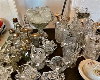 antique glassware, collection of water pitchers, creamer/sugar sets, and olive oil decanters 