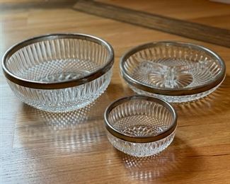 Crystal serving pieces with silver-plate rims.