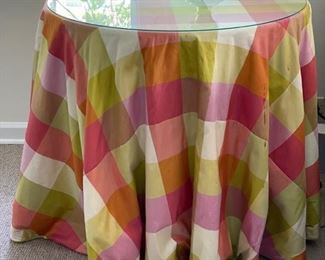 Pair of wood particle board round tables with buffalo plaid skirts