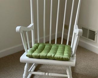White rocker with green cushion