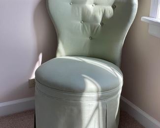 Side chair upholstered in pale green fabric with skirt