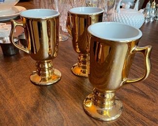 Set of three gold mugs