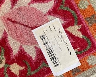 Custom area rug with pink and orange accents. Measures 8' x 10'. Photo 2 of 2