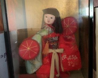 Adorable Geisha in shadow box. 