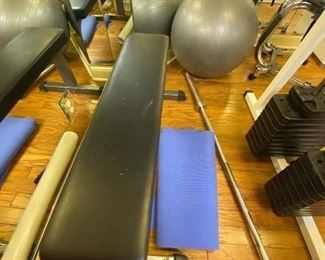Weight bench, bar, pilates ball, yoga mat.