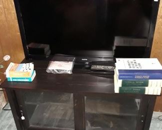 Sanyo flatscreen TV and console cabinet.