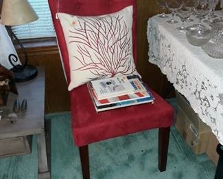 Chair, decorative pillows, rug, and books.