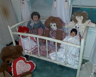 Antique baby cradle/rocker with vintage dolls.