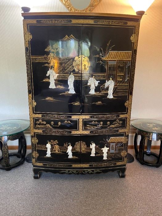 Asian lacquered cabinet with inlaid figures. Interior television storage and drawers below.  Matching barrel stools . Set of floor lamps also pictured.