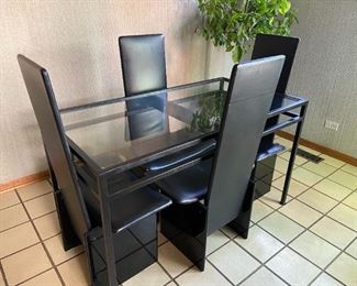 Metal and glass modern dining table.  Six highback leather chairs (2 not pictured) Items sold separately or as a set.