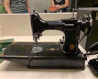Vintage Featherweight Singer Centennial Sewing Machine has original case, instructions, additional pieces. In excellent working condition; looks new!