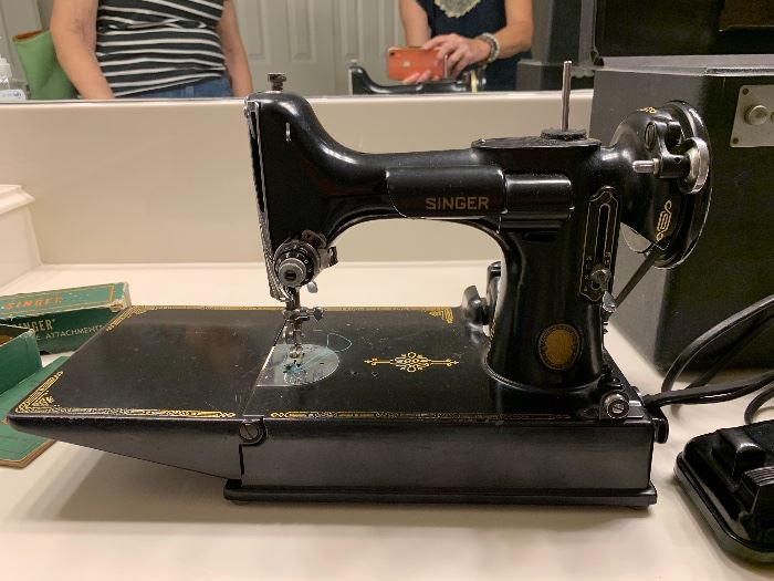 Vintage Featherweight Singer Centennial Sewing Machine has original case, instructions, additional pieces. In excellent working condition; looks new!